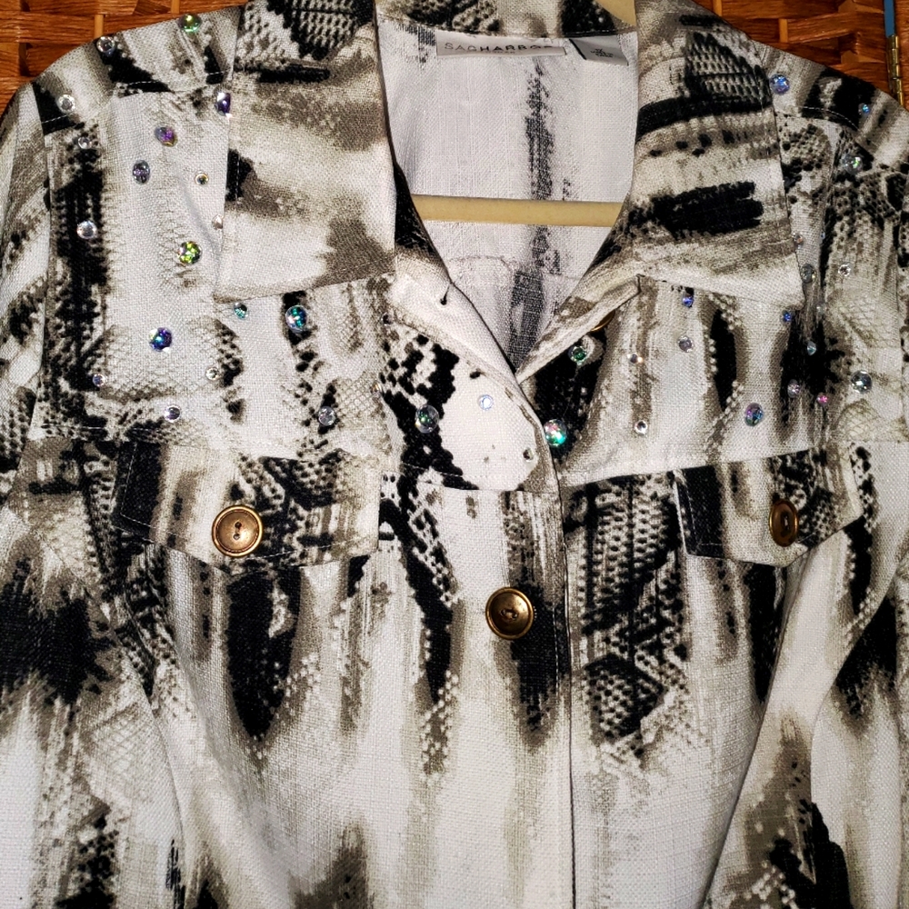 This unique jacket customized with beading and a removable corset strap.